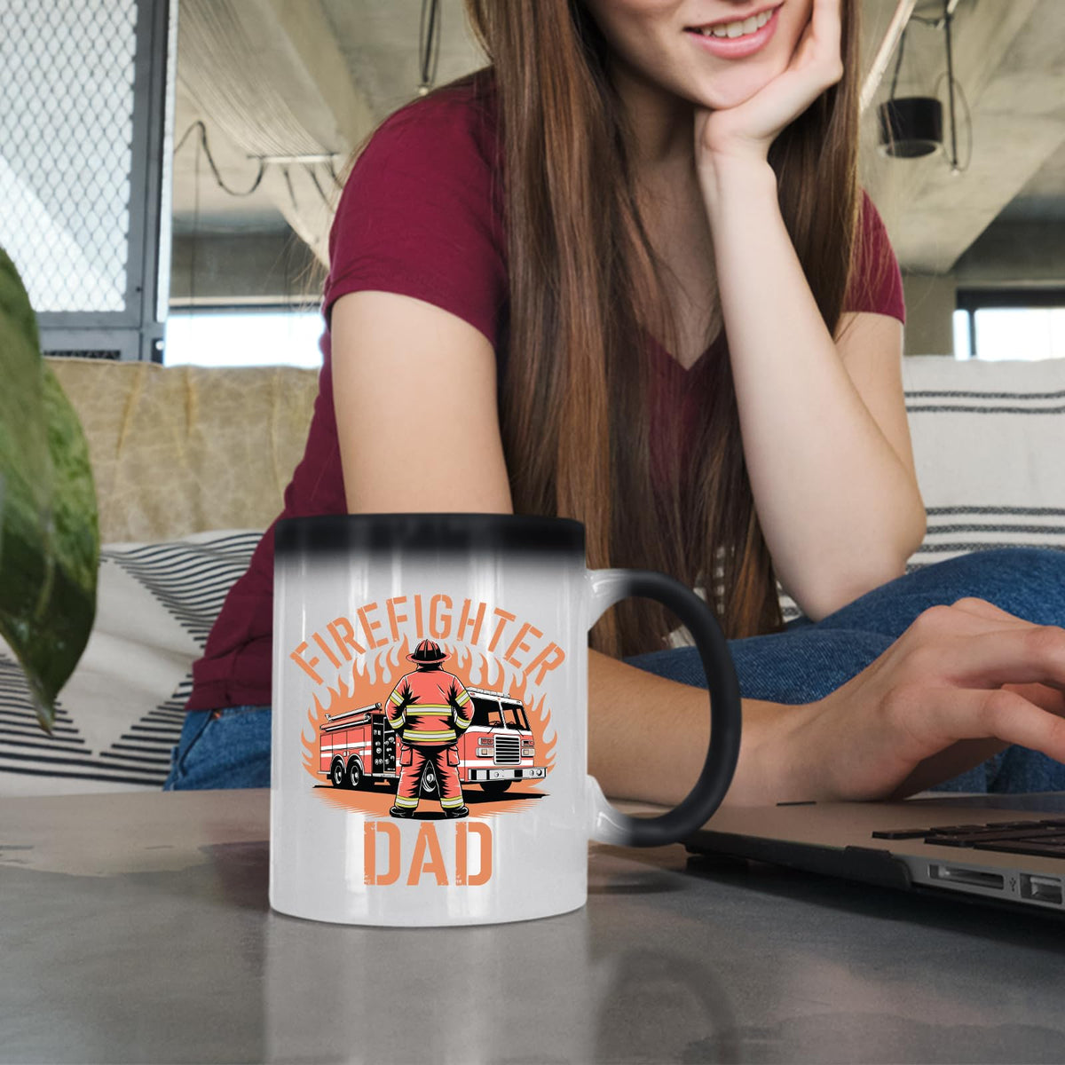 Woman at a laptop with the Firefighter Dad colour changing mug