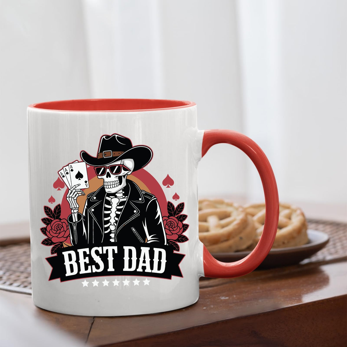 Best Dad skeleton cowboy mug with a red handle beside biscuits