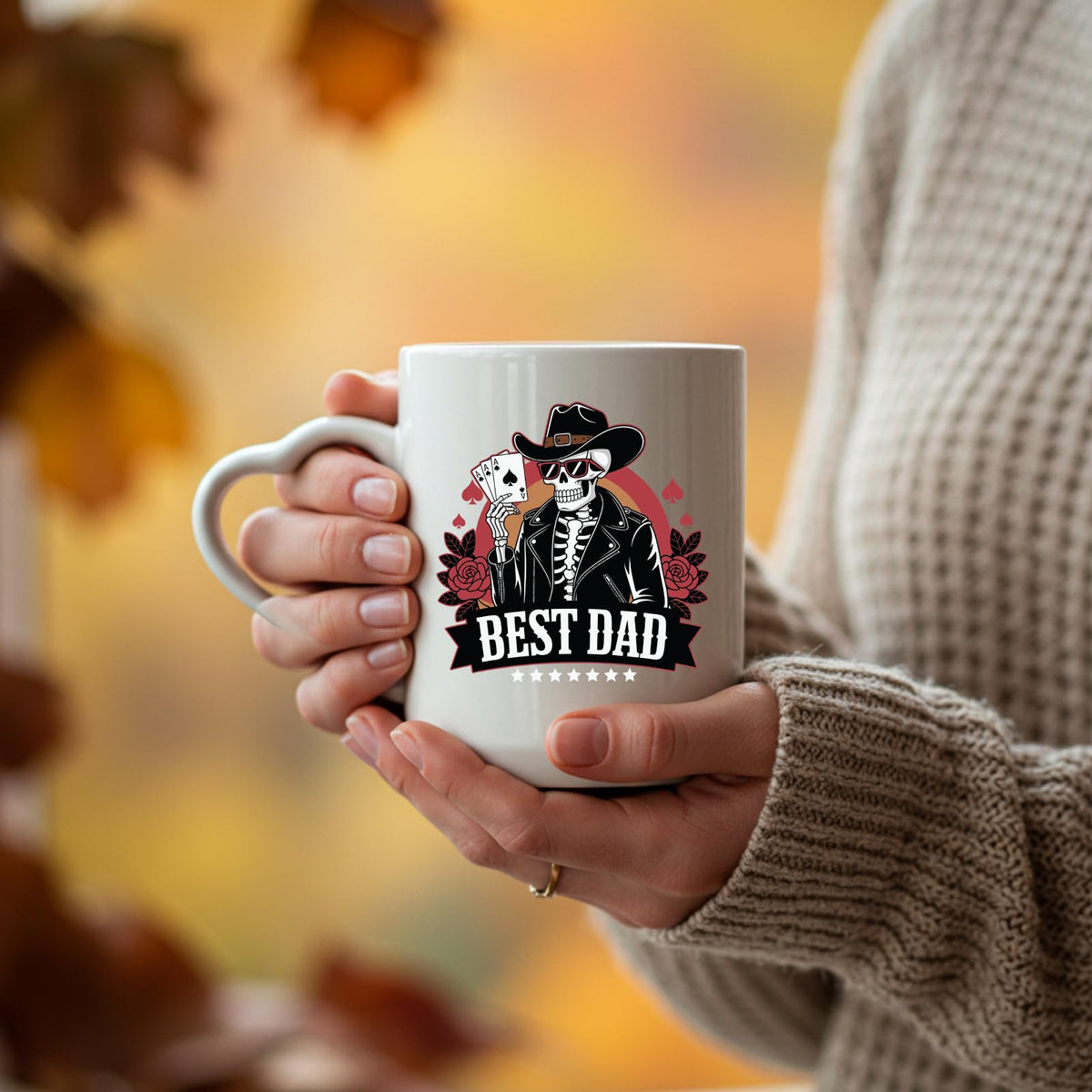 Hands holding the Best Dad skeleton cowboy heart-handle mug