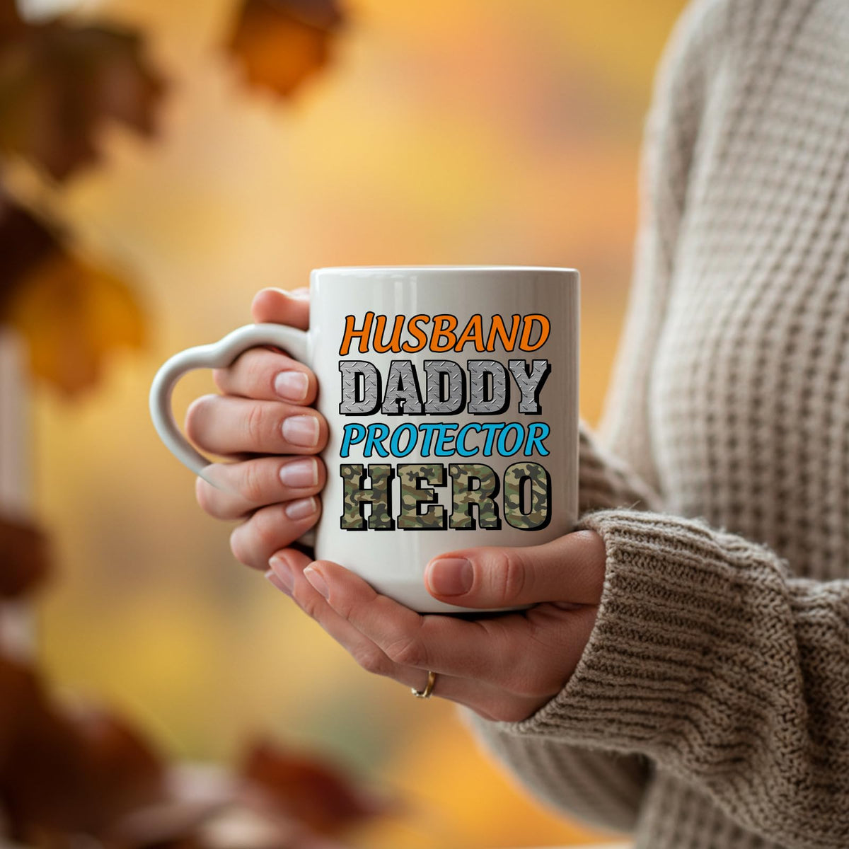 Hands holding the Husband Daddy Protector Hero camo heart-handle mug