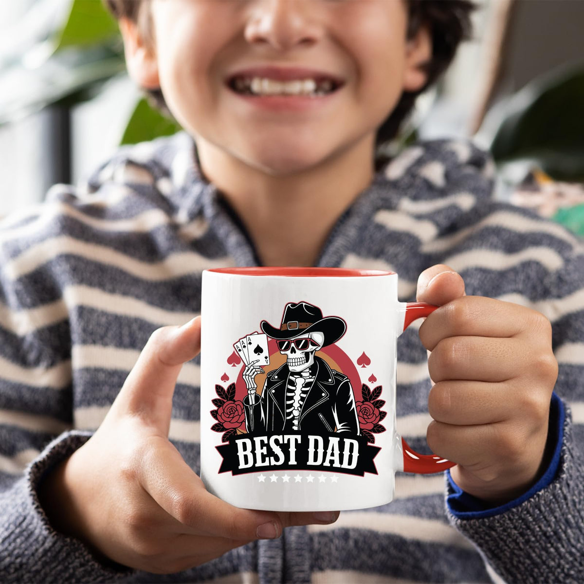 Smiling child holding the Best Dad skeleton cowboy mug with a red handle