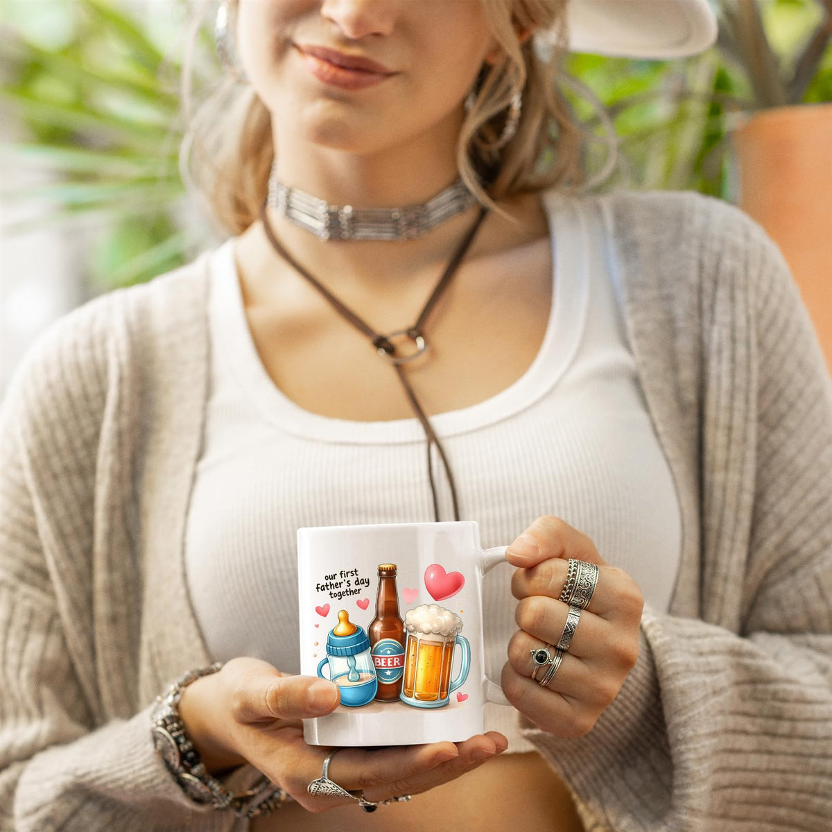 Woman in a cardigan holding the First Father’s Day hearts mug
