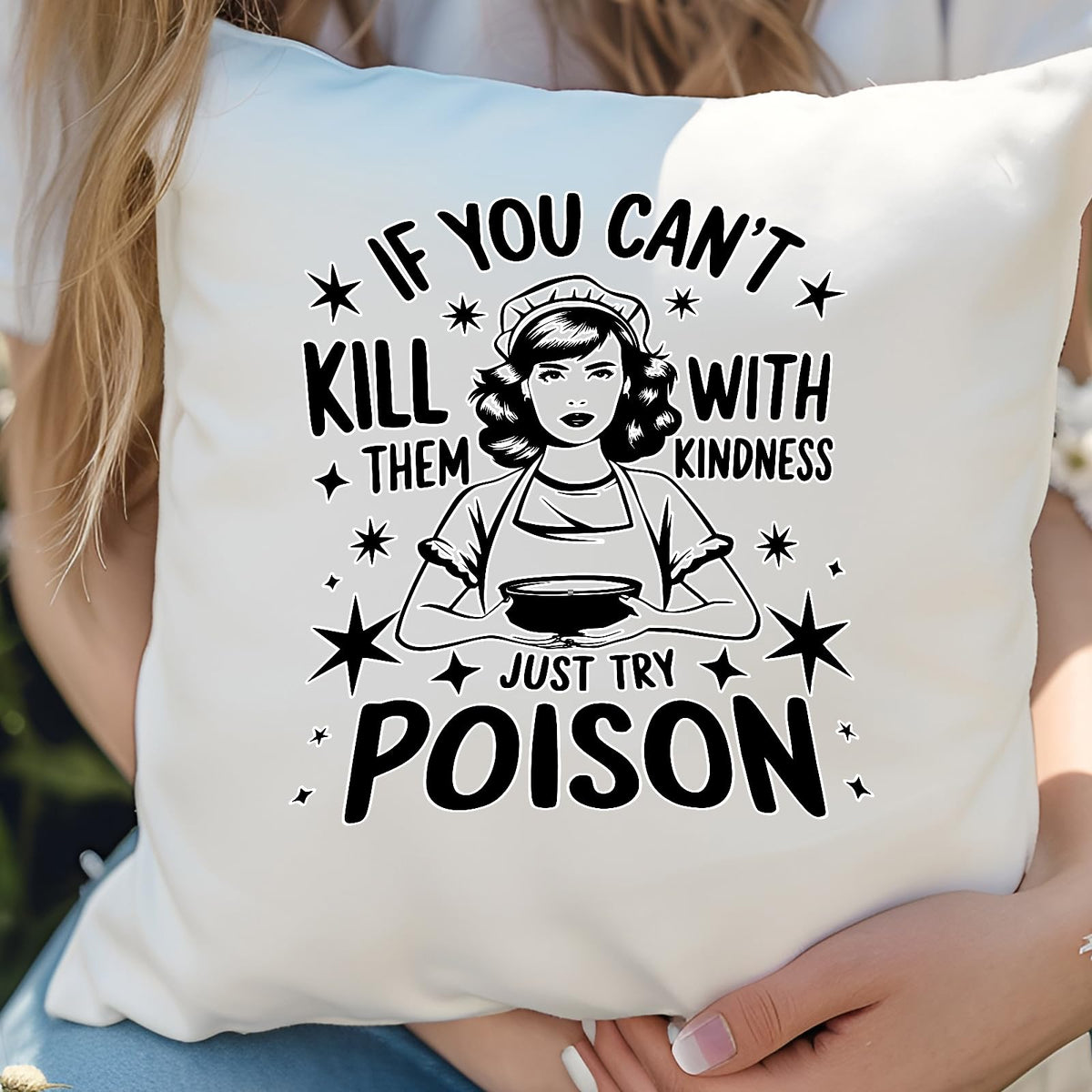 Hands holding the Just Try Poison cushion