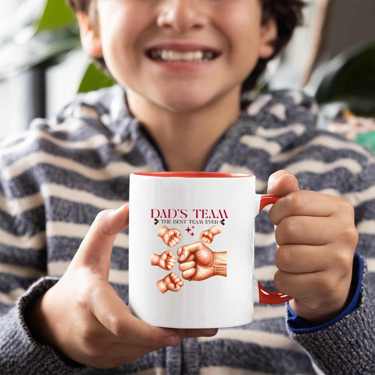 Smiling child holding the Dad’s Team fist bump mug with a red handle