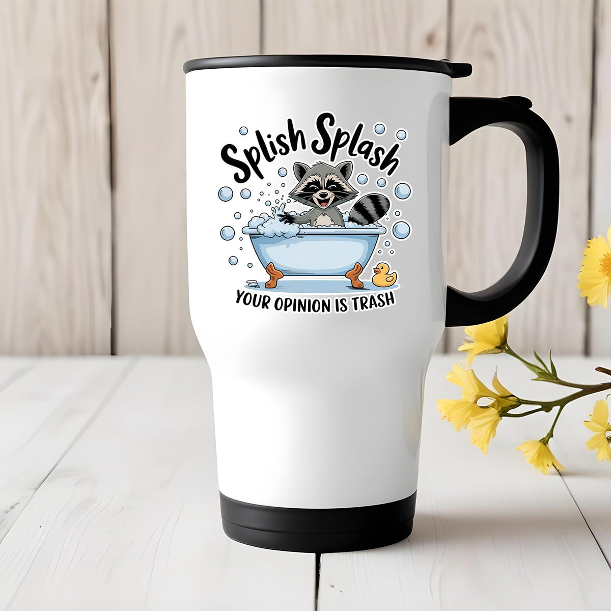 Splish Splash raccoon travel mug on a white wooden table with yellow flowers