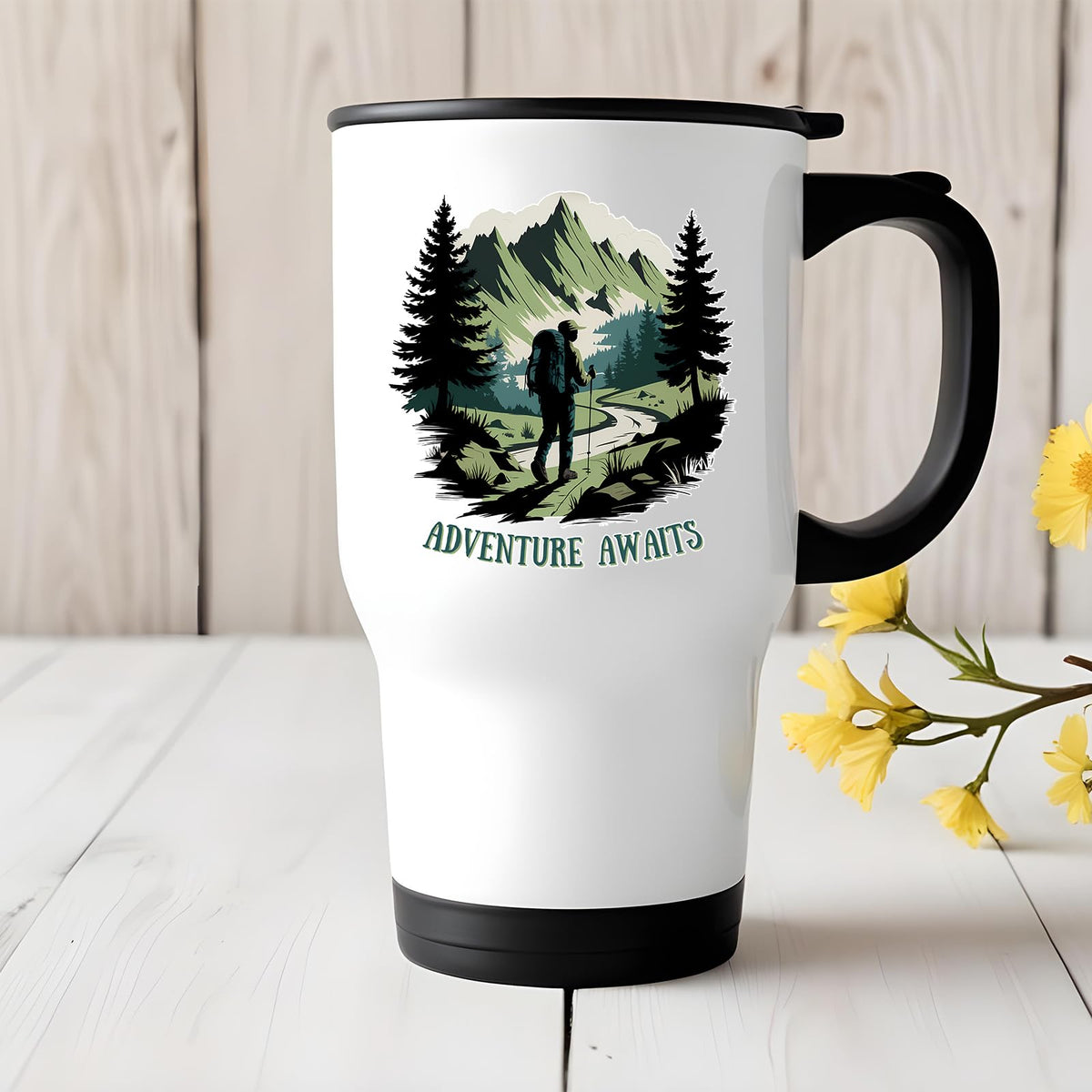 Adventure Awaits hiker travel mug on a white wooden table with yellow flowers