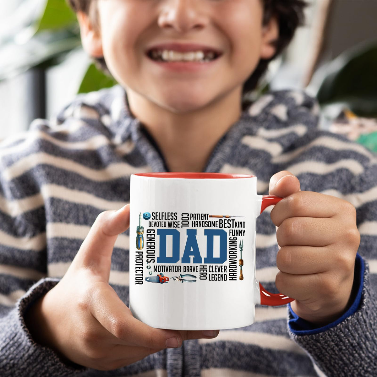 Smiling child holding the DAD word cloud mug with a red handle