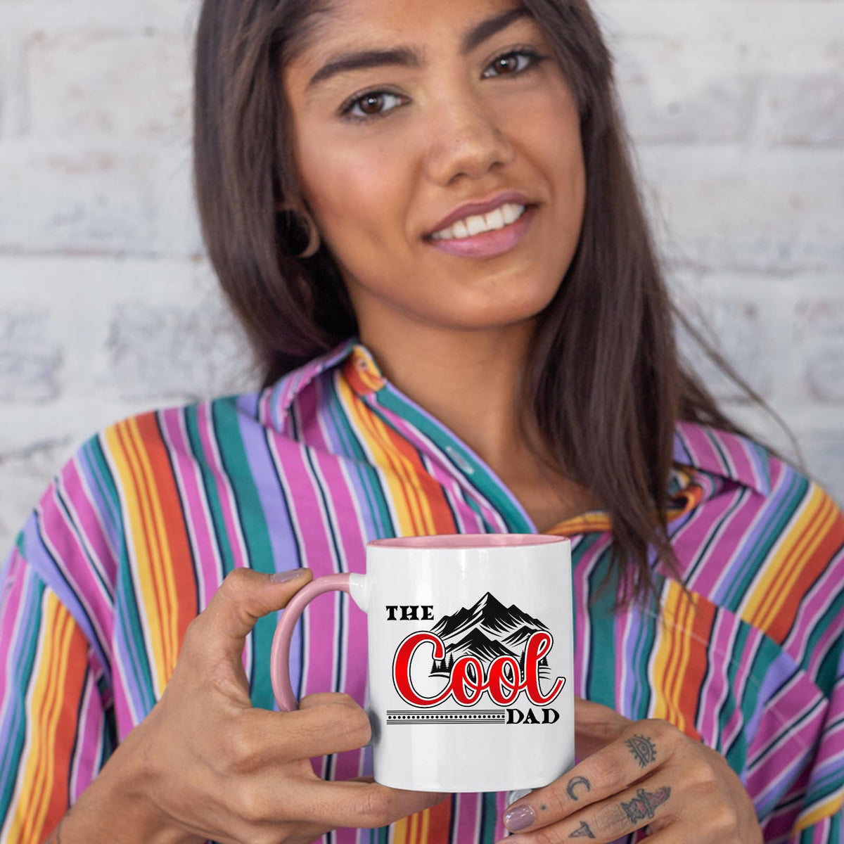 Woman in a striped shirt holding the The Cool Dad mountains colour handle mug