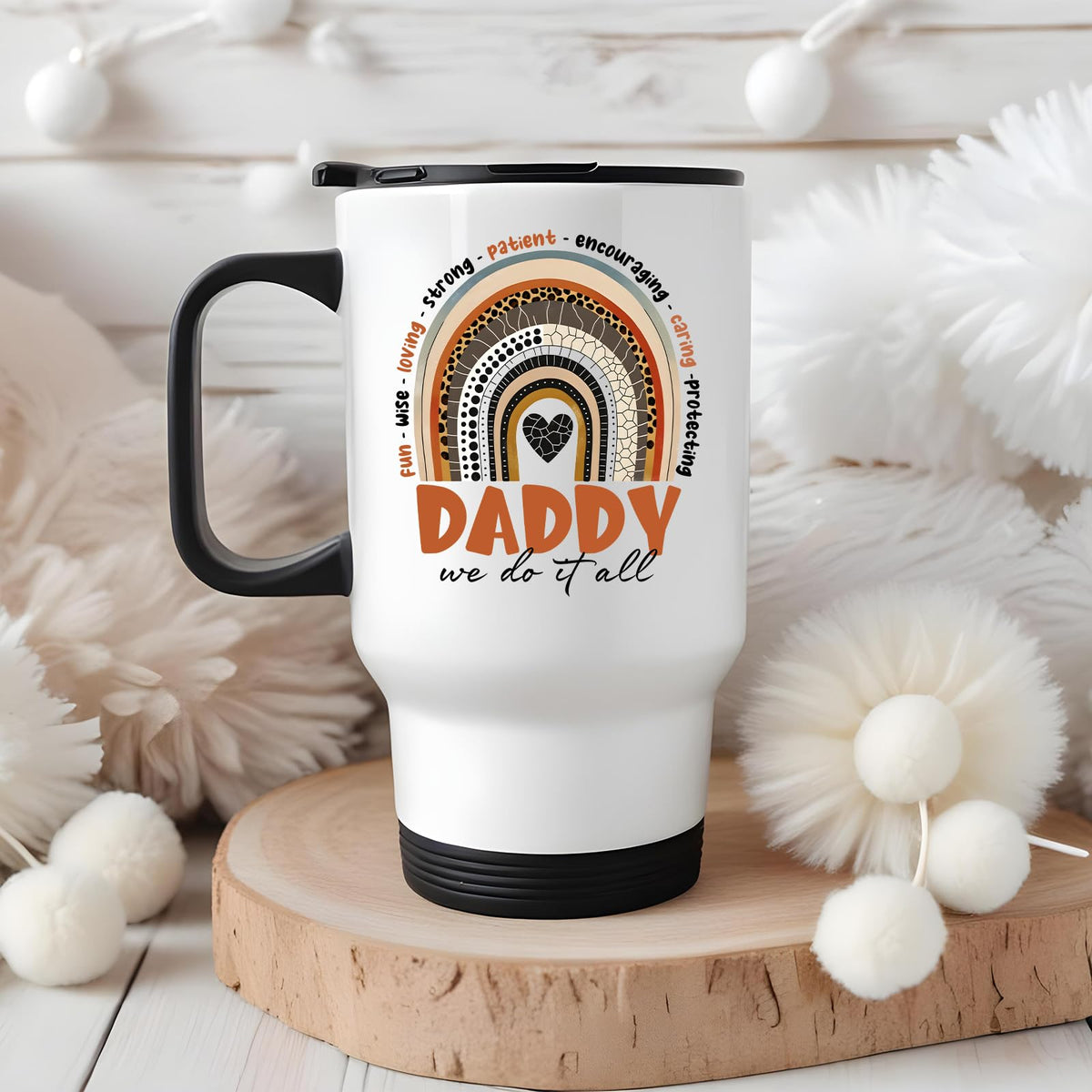 Daddy boho rainbow travel mug on a wooden slice with white pom-poms