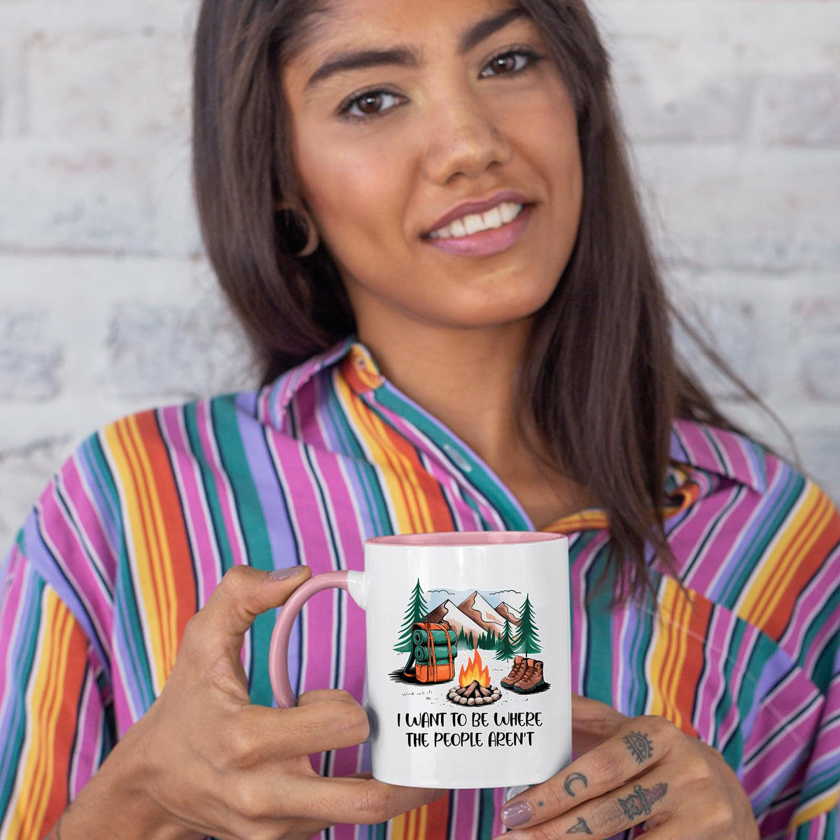 Woman in a striped shirt holding the camping escape colour handle mug
