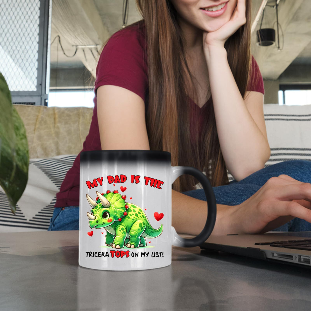 Woman at a laptop with the Triceratops dad colour changing mug