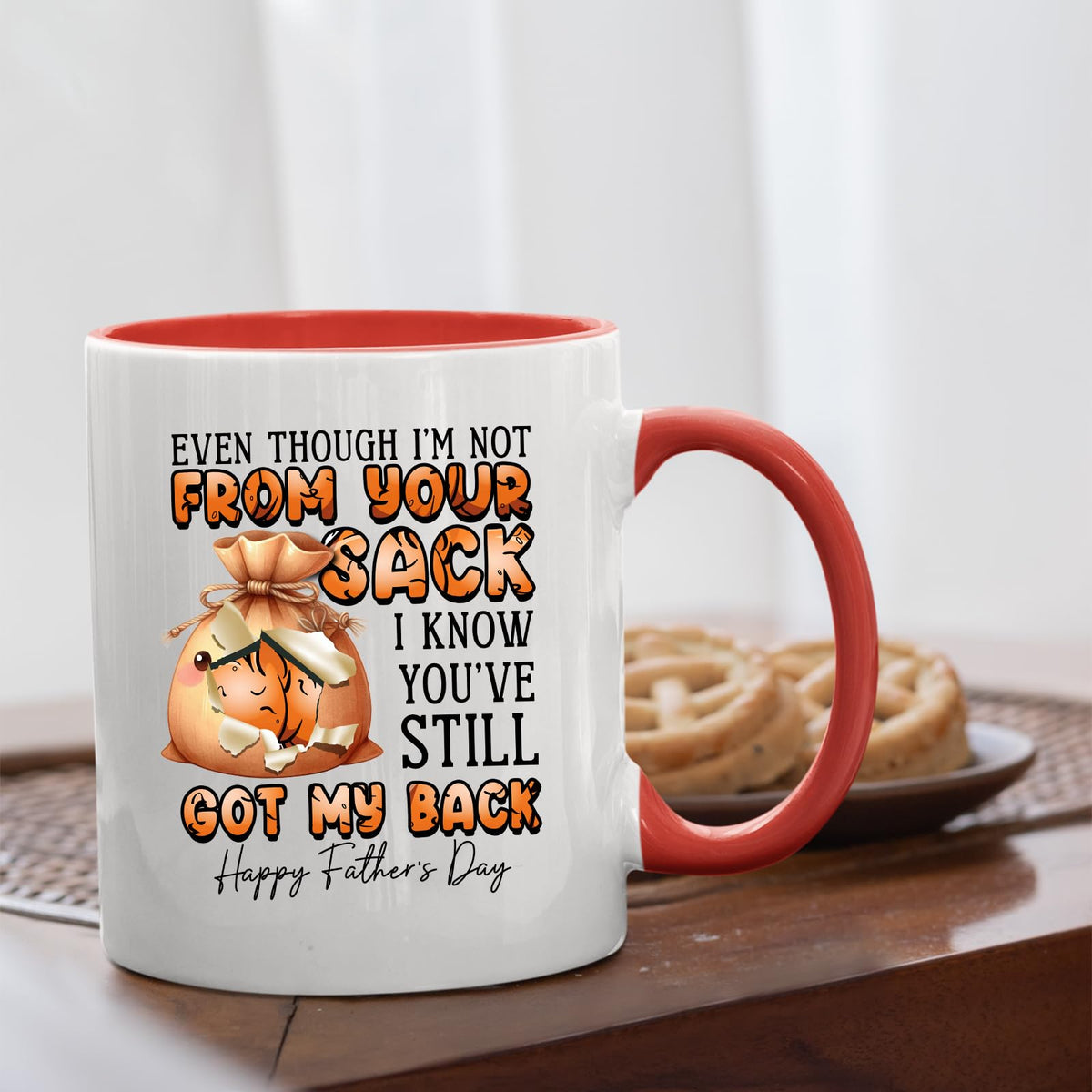 Not From Your Sack mug with a red handle beside biscuits