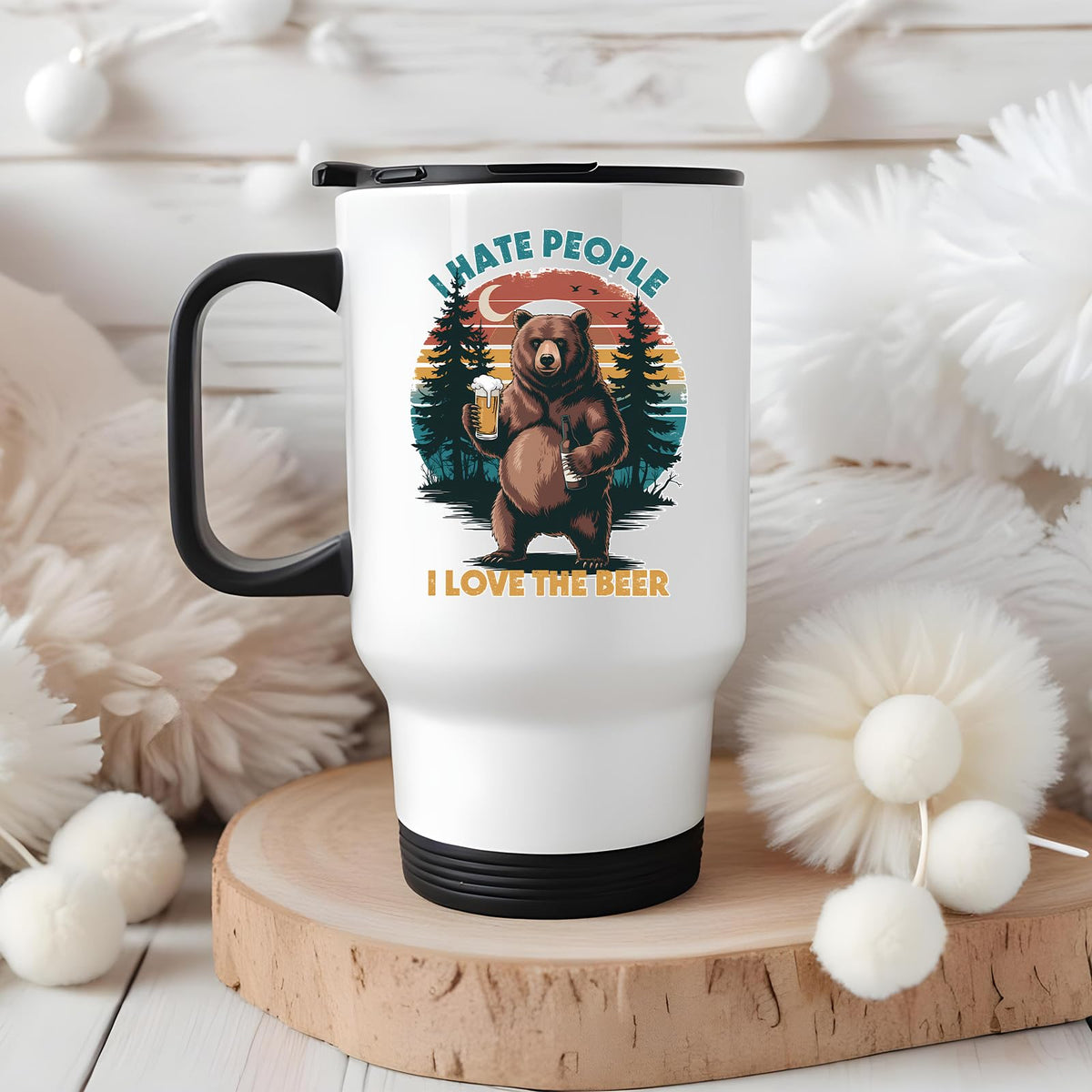 beer-loving bear travel mug on a wooden slice with white pom-poms