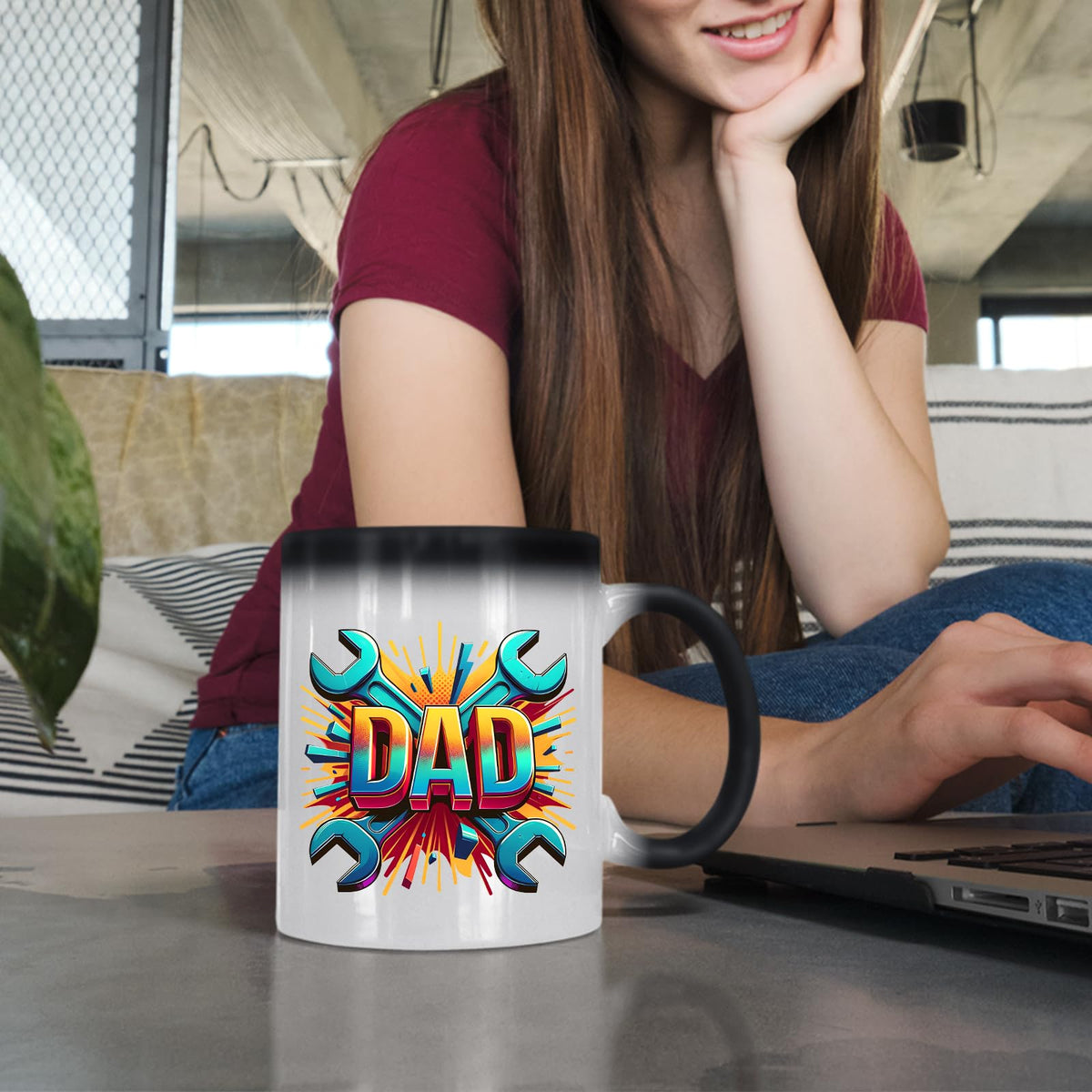 Woman at a laptop with the DAD spanners colour changing mug