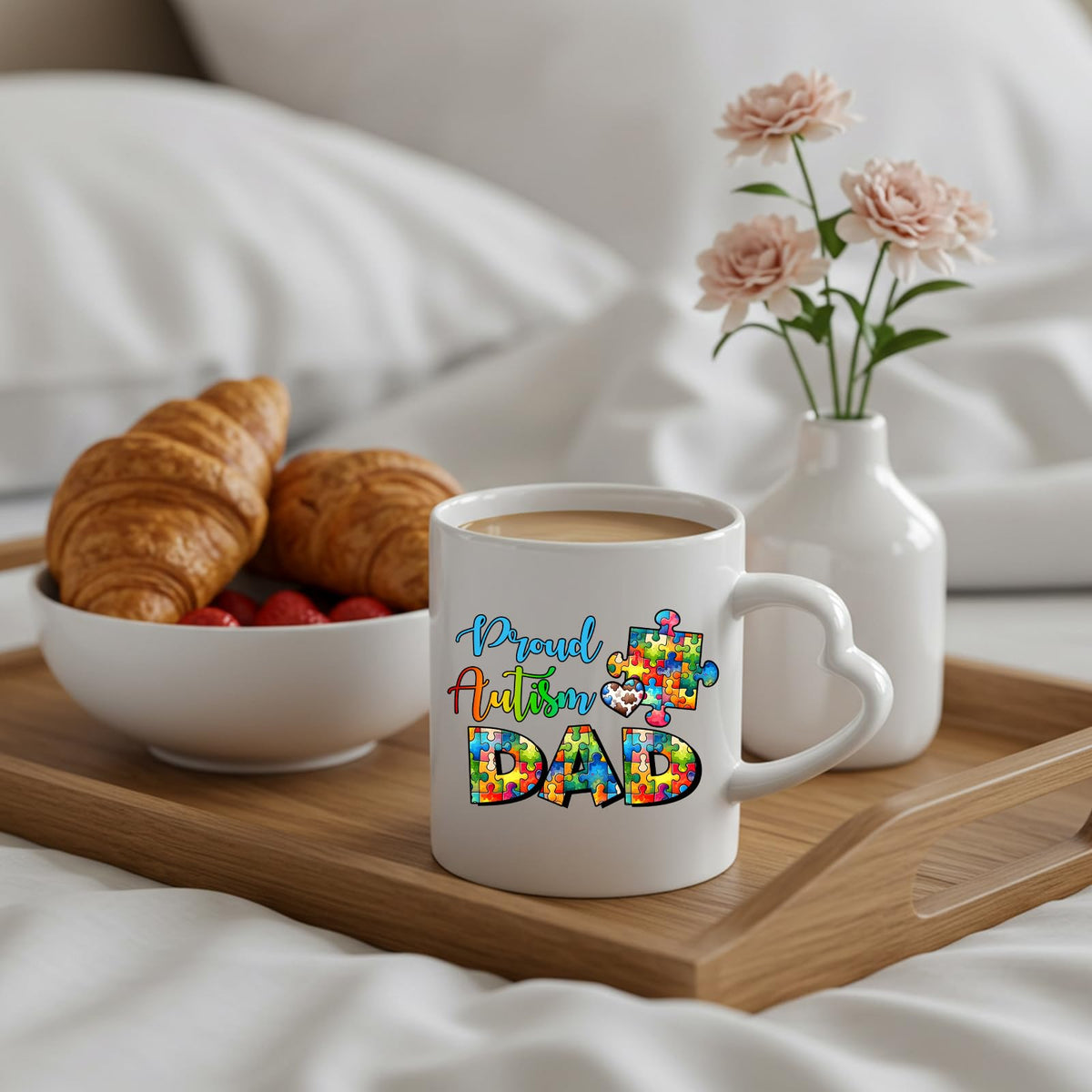 Proud Autism Dad heart-handle mug on a breakfast tray with croissants and flowers