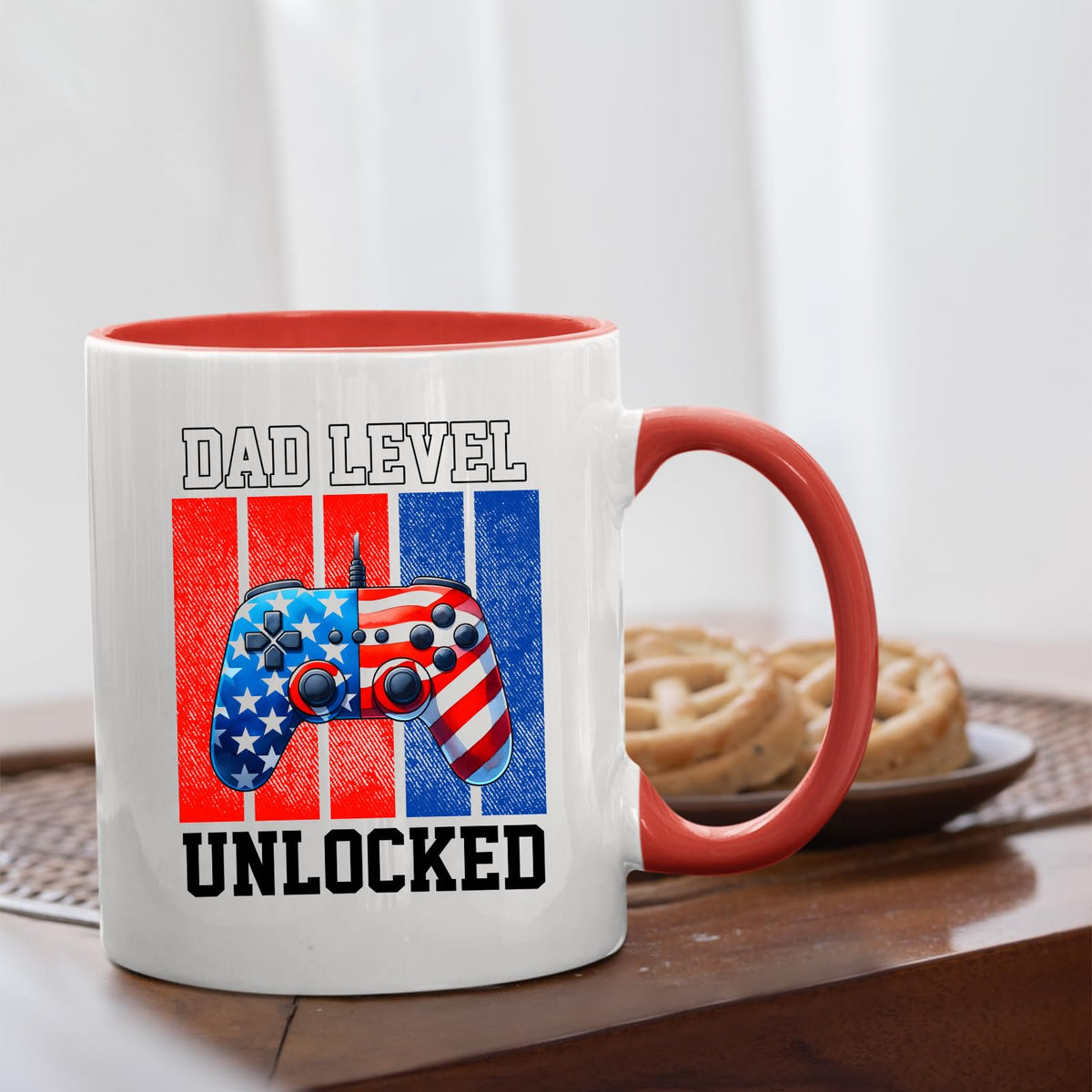 Dad Level Unlocked mug with a red handle beside biscuits