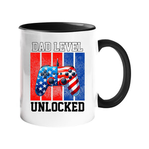 Colour handle mug with a stars-and-stripes game controller and “Dad level unlocked” – black handle and inside