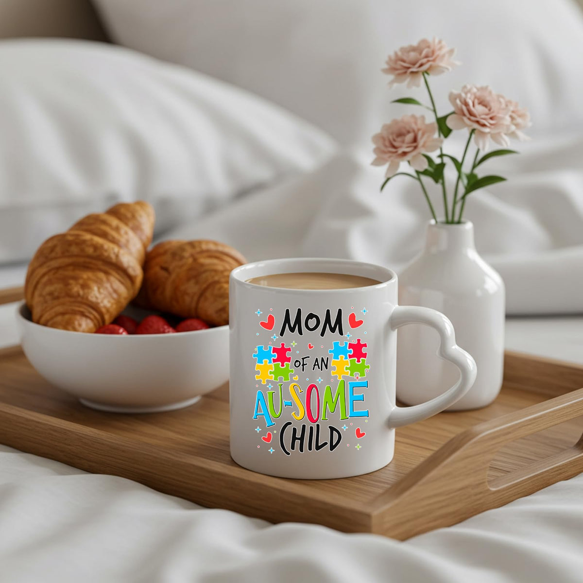 Mom of an Au-Some Child heart-handle mug on a breakfast tray with croissants and flowers