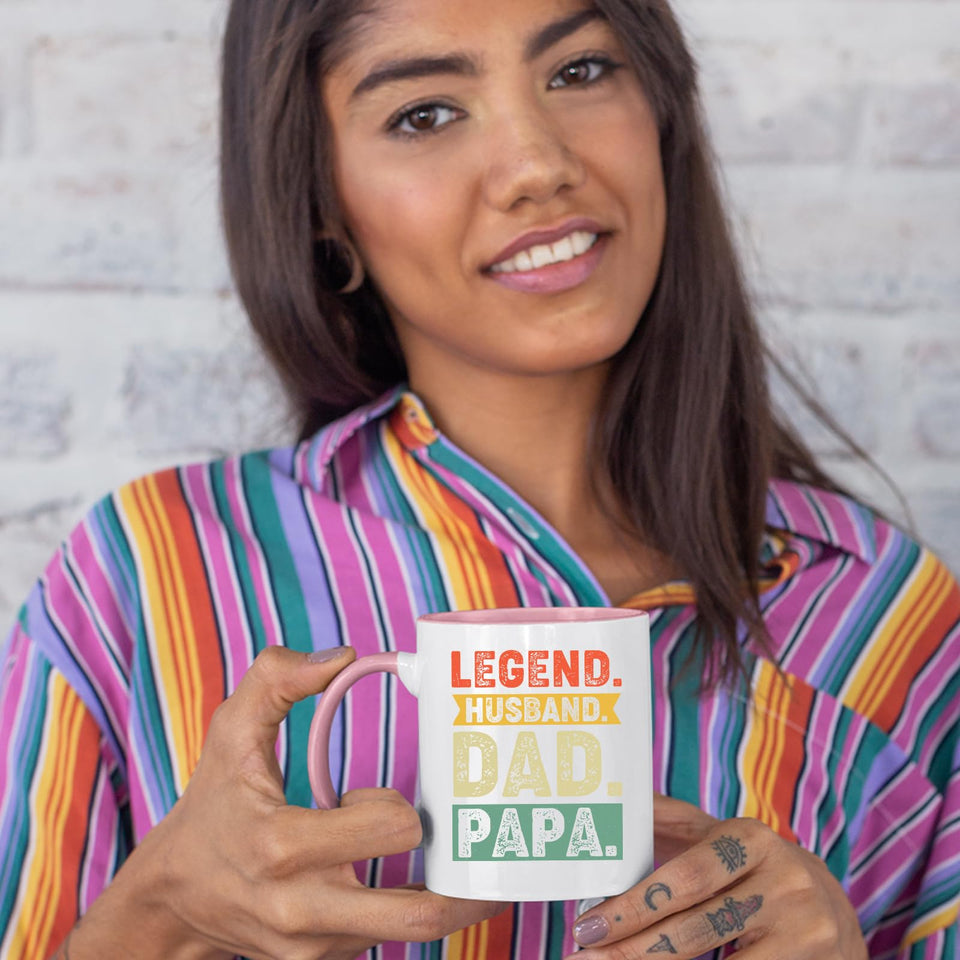 Woman in a striped shirt holding the Legend Husband Dad Papa colour handle mug