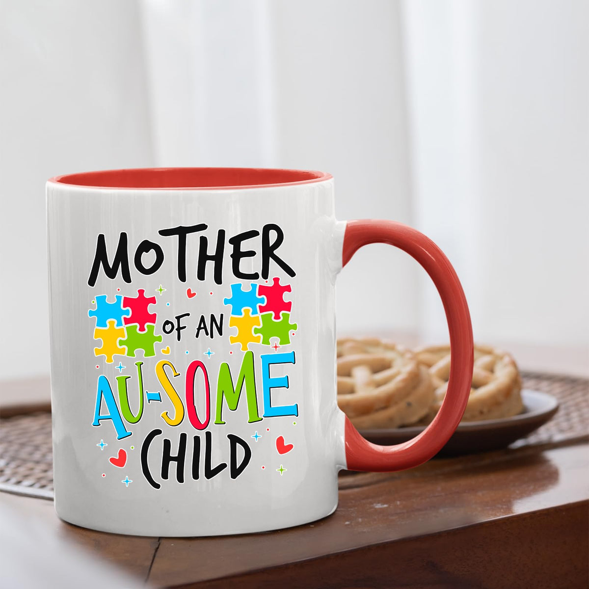 Mother of an Au-Some Child mug with a red handle beside biscuits