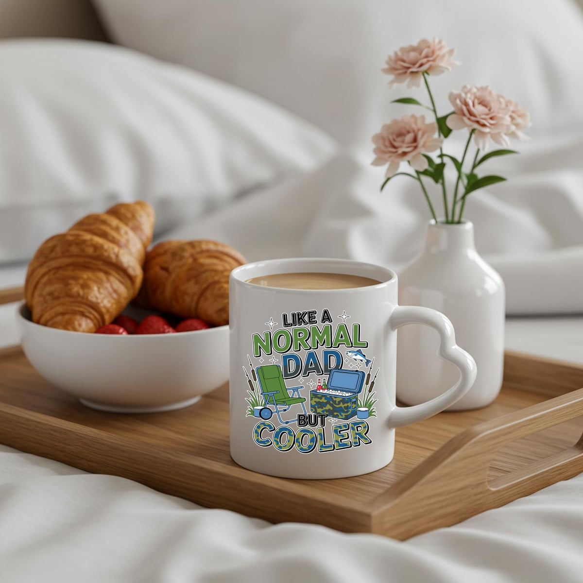 Like a Normal Dad But Cooler heart-handle mug on a breakfast tray with croissants and flowers