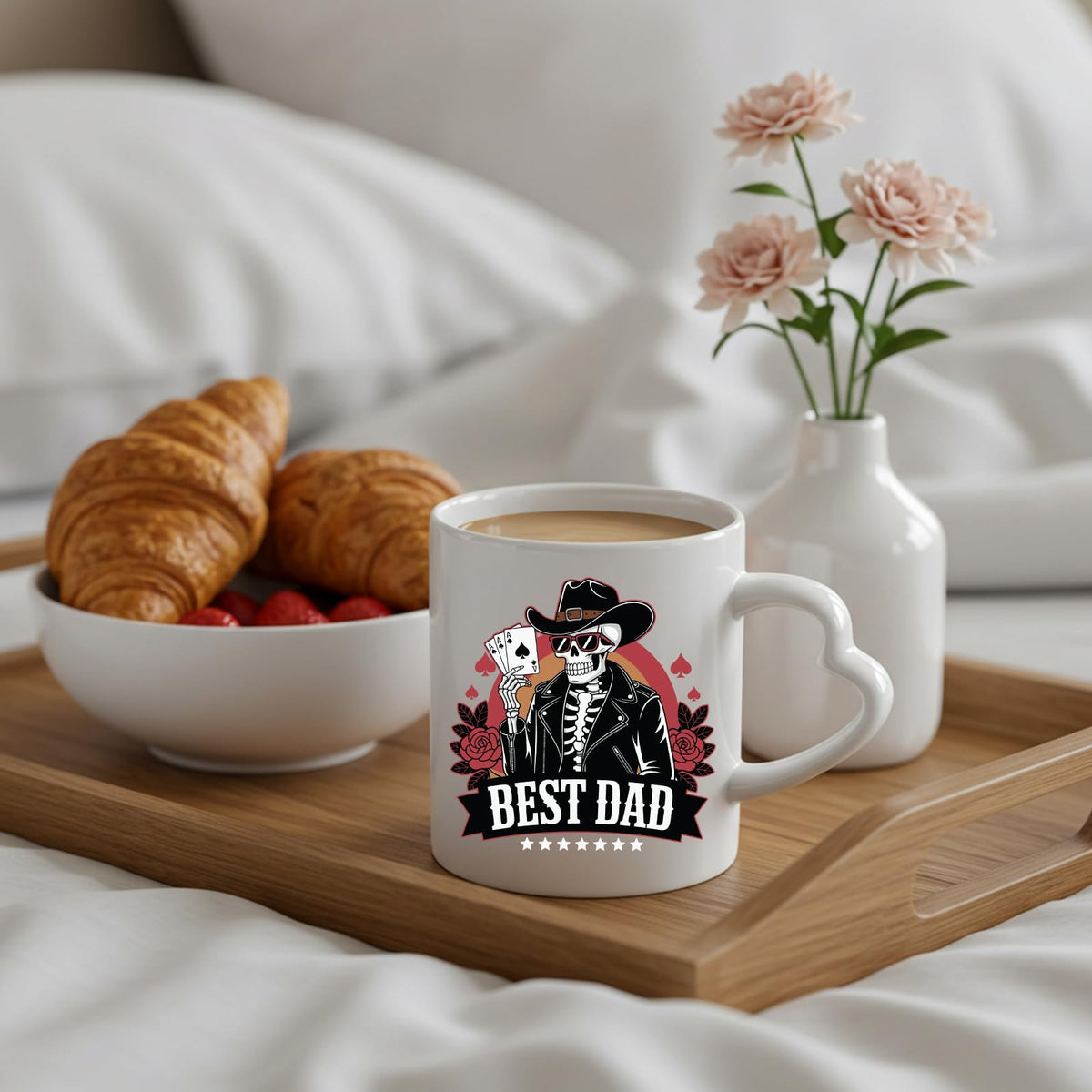 Best Dad skeleton cowboy heart-handle mug on a breakfast tray with croissants and flowers