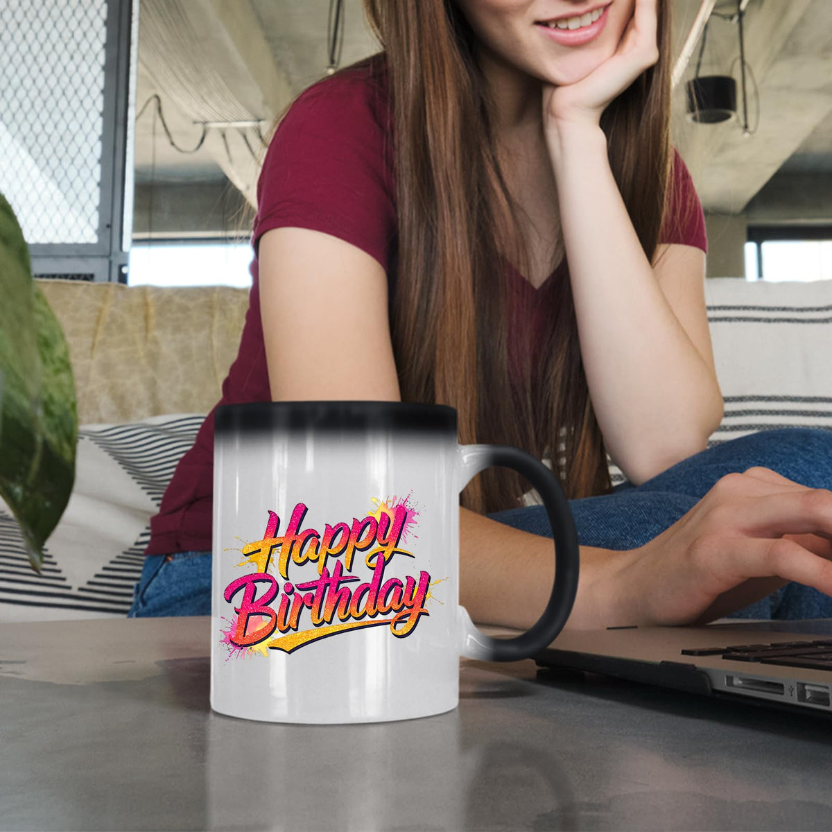 Woman at a laptop with the Happy Birthday pink and gold colour changing mug