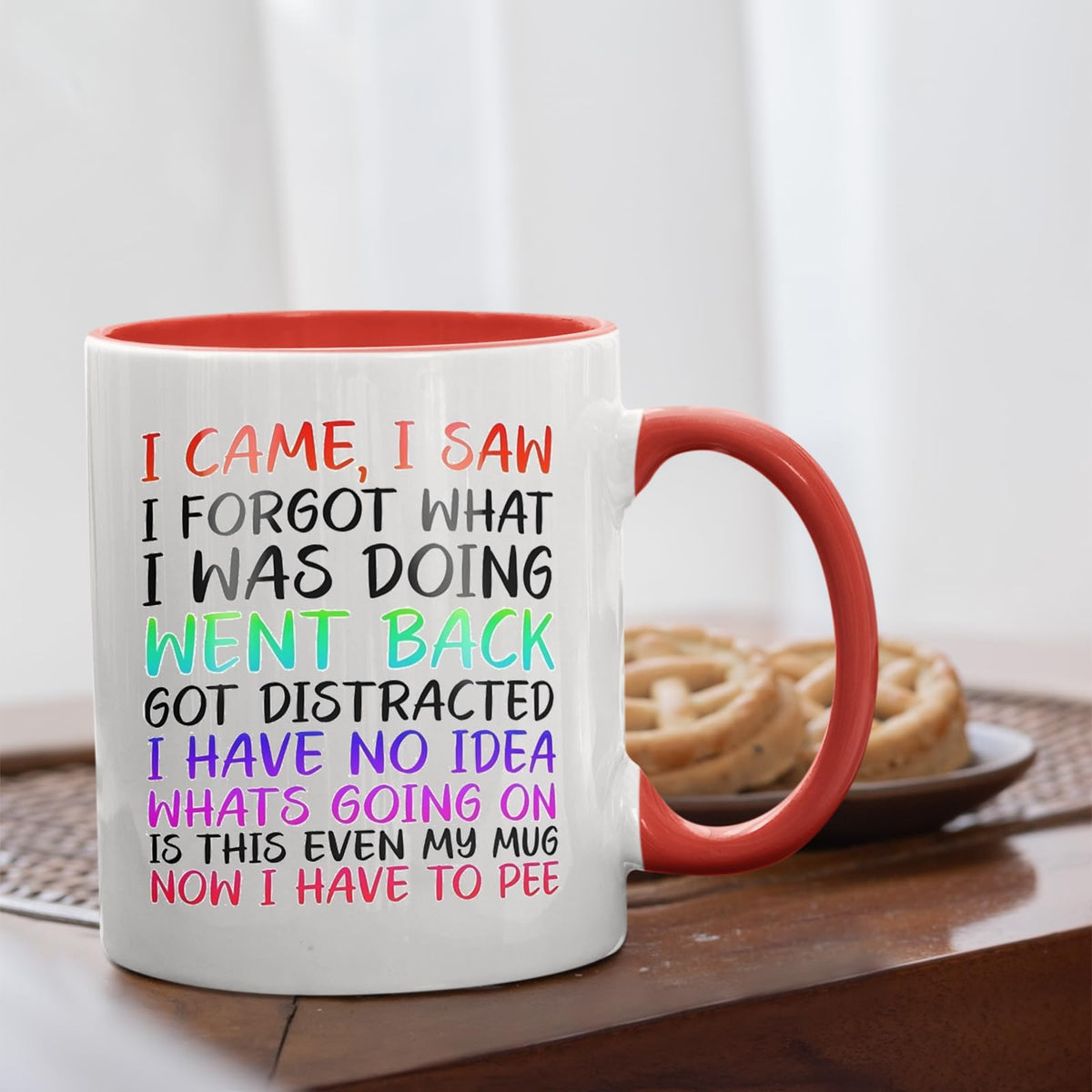 I Came I Saw I Forgot mug with a red handle beside biscuits