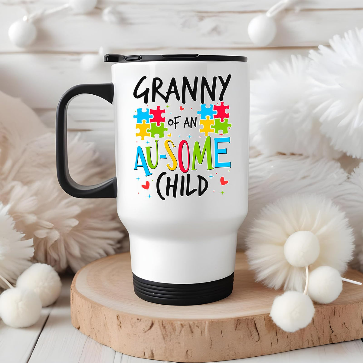 Granny of an Au-Some Child travel mug on a wooden slice with white pom-poms