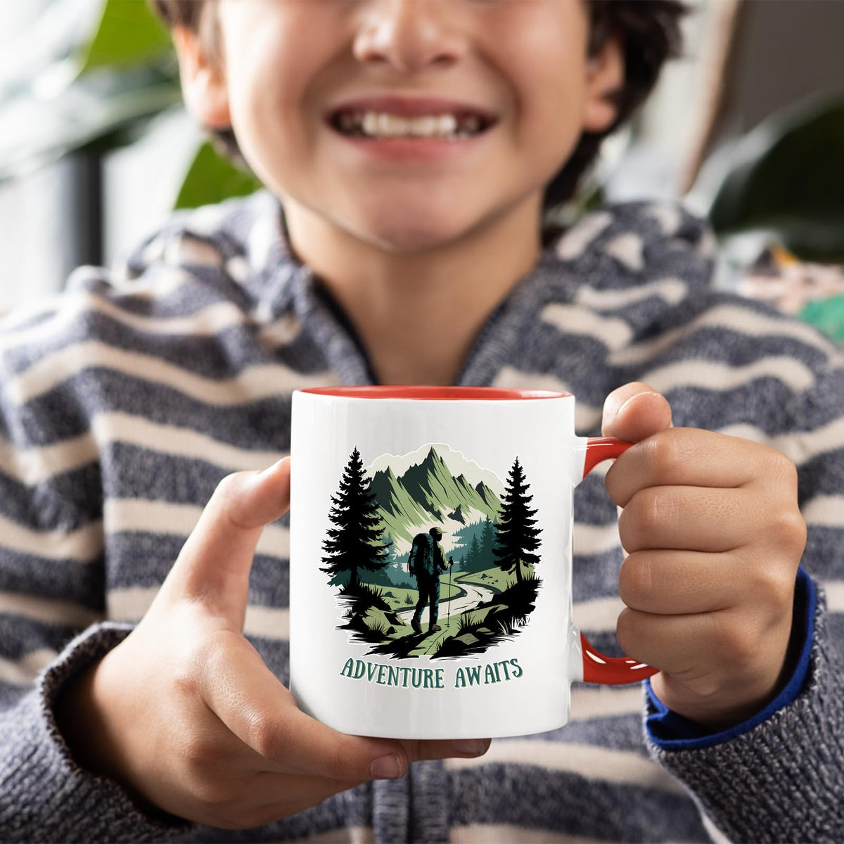 Smiling child holding the Adventure Awaits hiker mug with a red handle