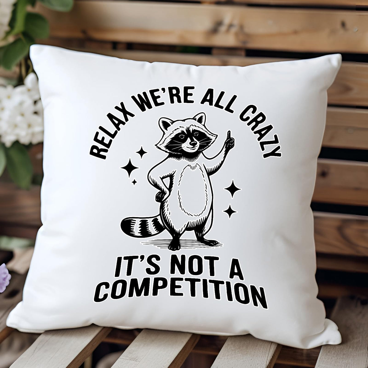 Relax We’re All Crazy raccoon cushion on a wooden bench