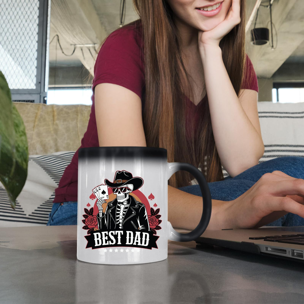 Woman at a laptop with the Best Dad skeleton cowboy colour changing mug