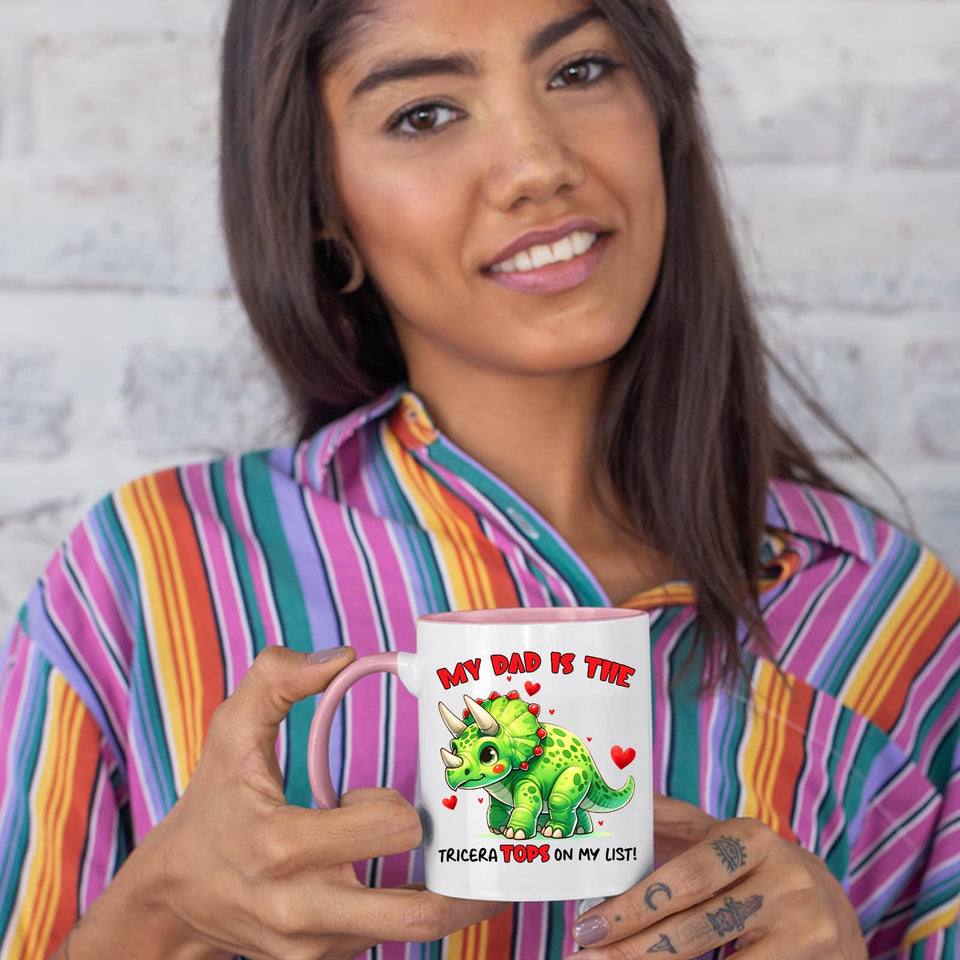 Woman in a striped shirt holding the Triceratops dad colour handle mug