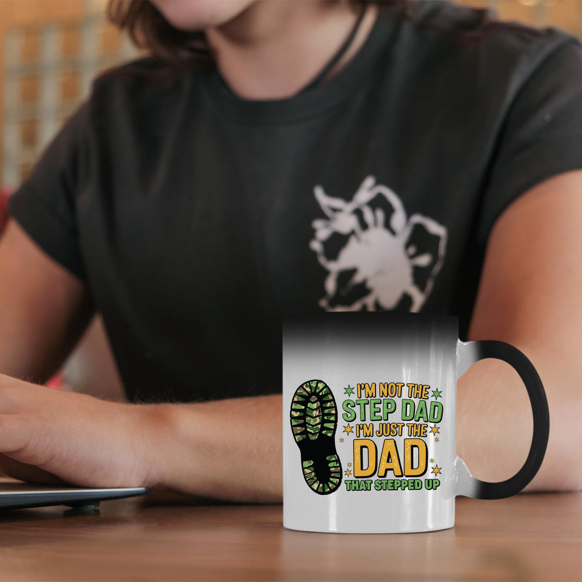 Dad That Stepped Up colour changing mug on a desk beside a laptop
