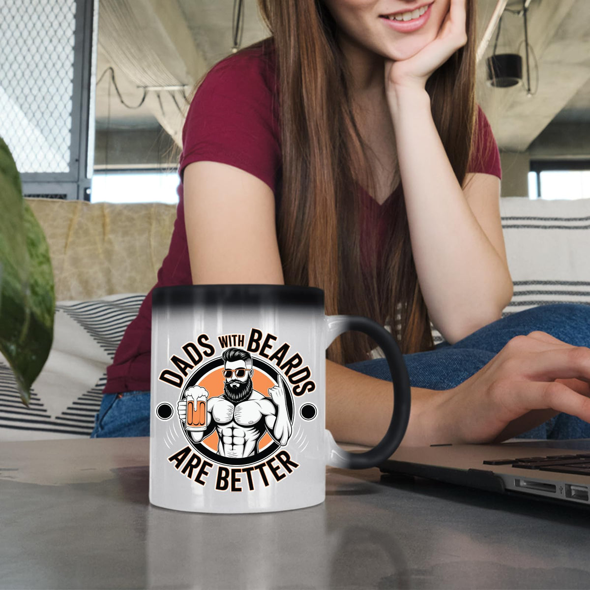 Woman at a laptop with the Dads with Beards colour changing mug
