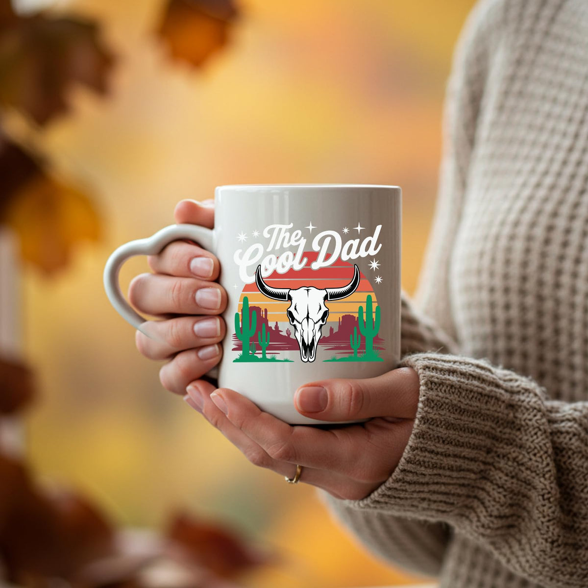 Hands holding the The Cool Dad bull skull heart-handle mug