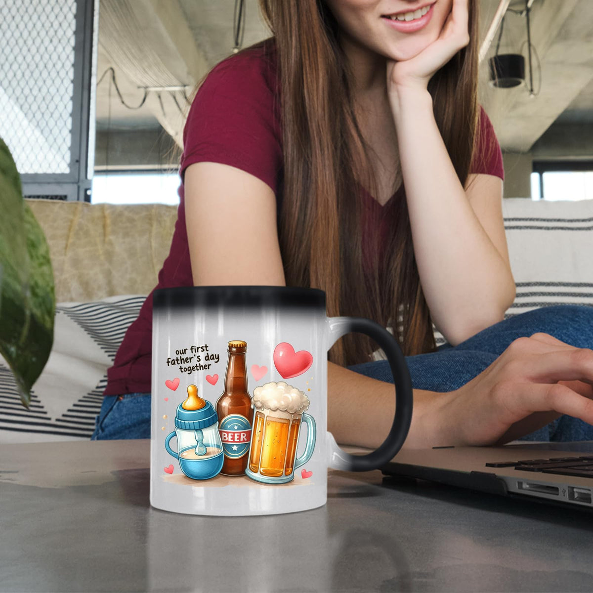 Woman at a laptop with the First Father’s Day hearts colour changing mug