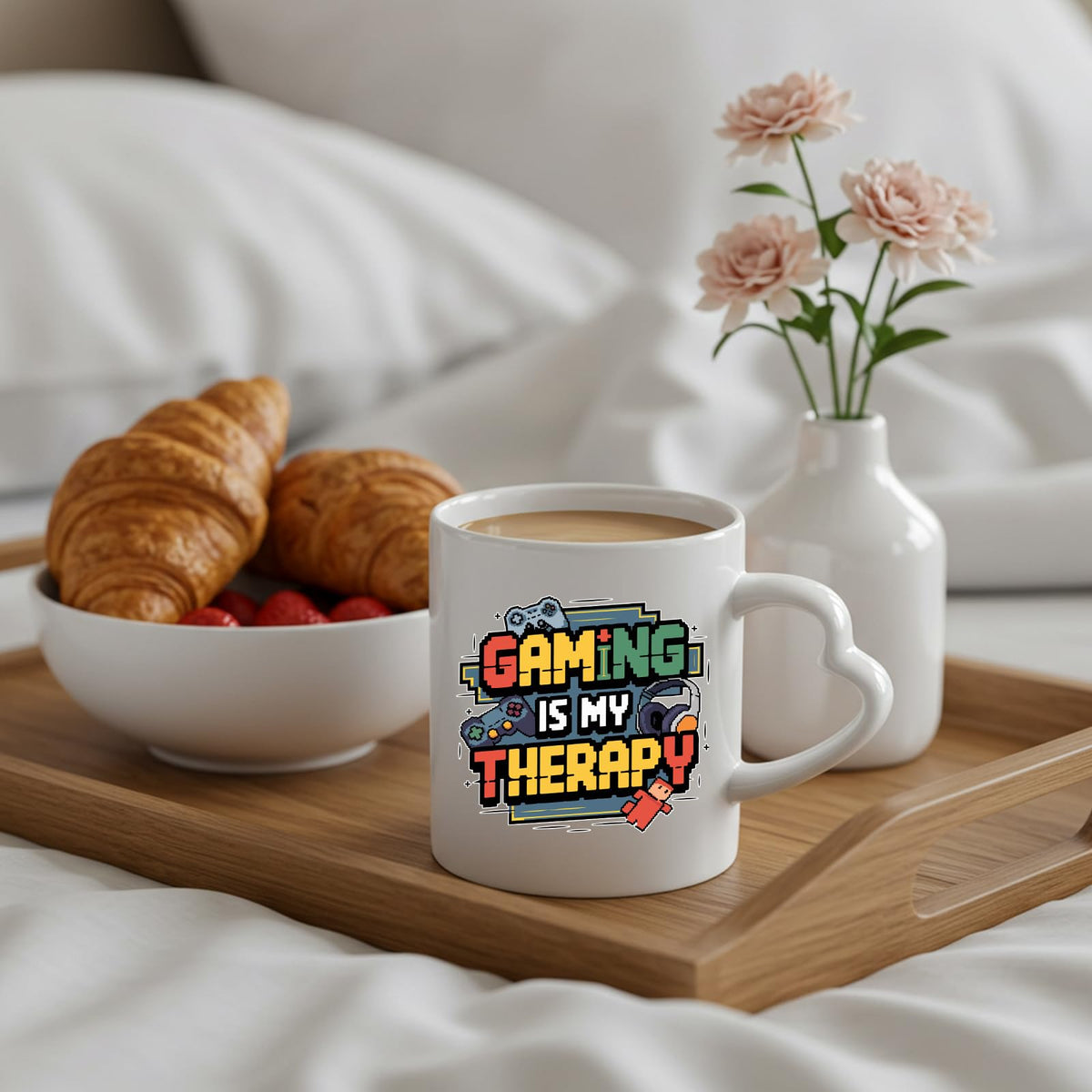 Gaming Is My Therapy heart-handle mug on a breakfast tray with croissants and flowers