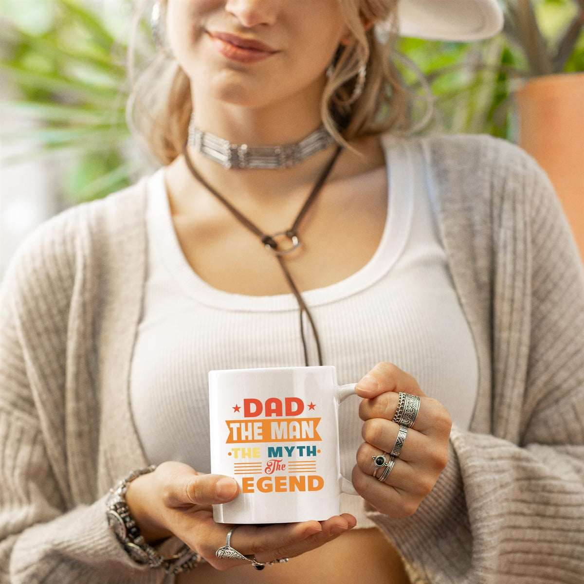 Woman in a cardigan holding the Dad the Man retro mug
