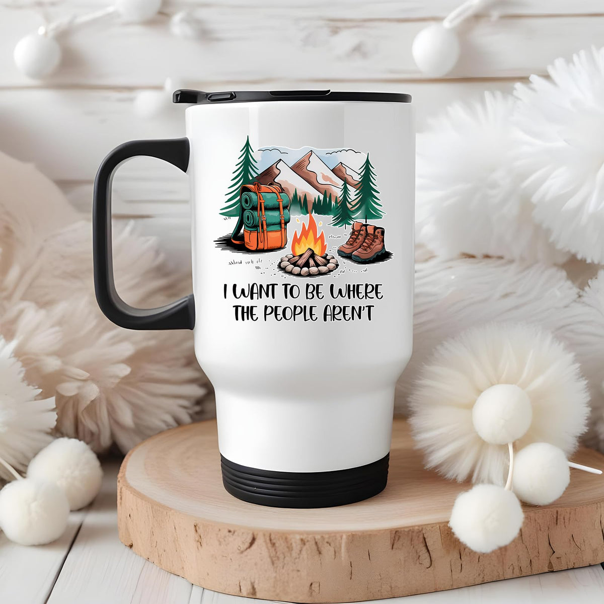 camping escape travel mug on a wooden slice with white pom-poms