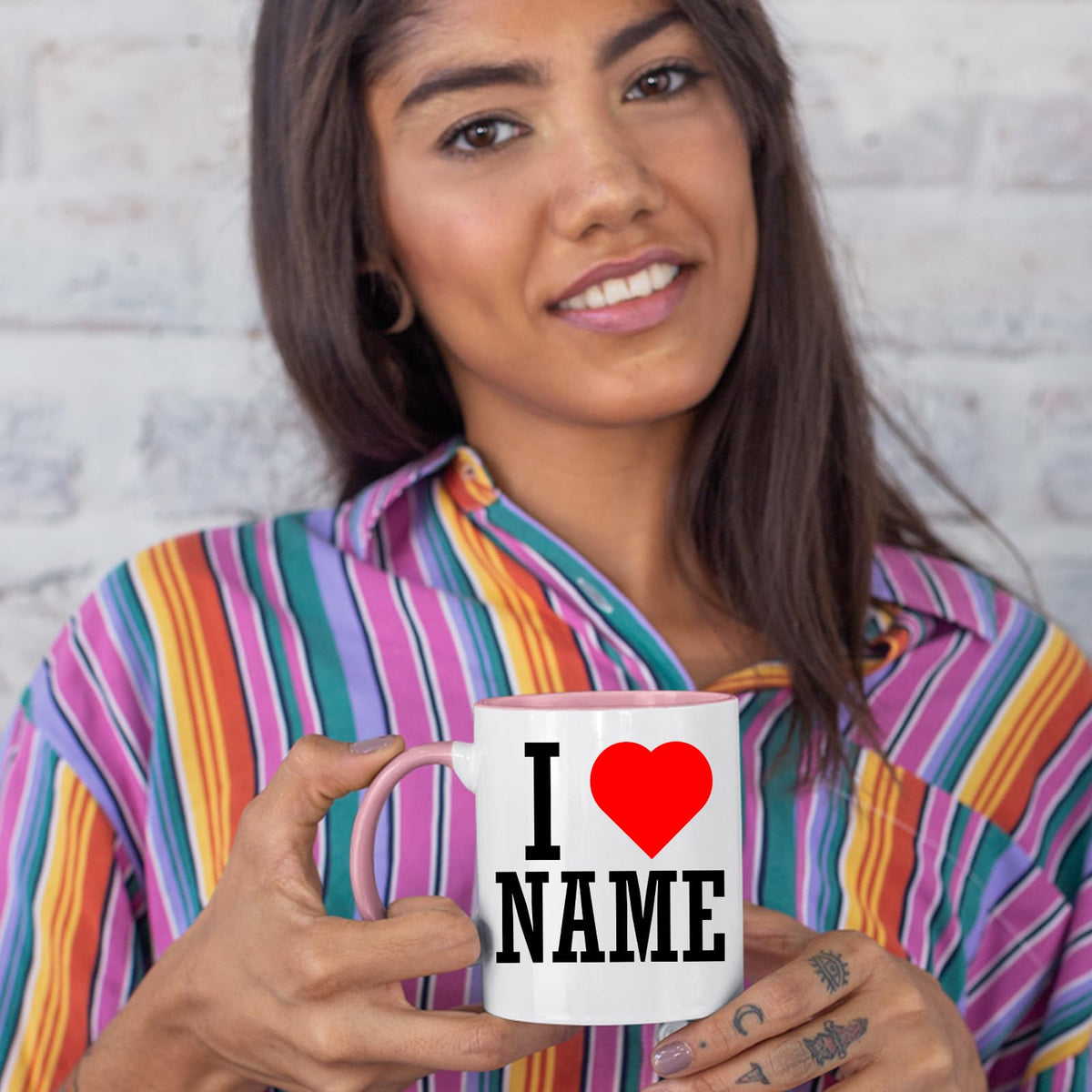 Woman in a striped shirt holding an I love name colour handle mug