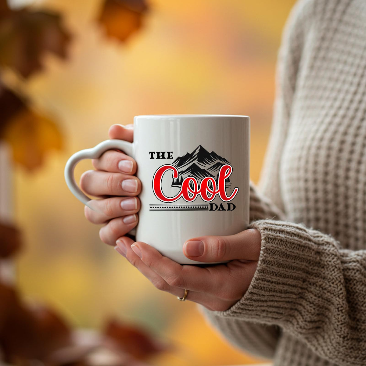 Hands holding the The Cool Dad mountains heart-handle mug