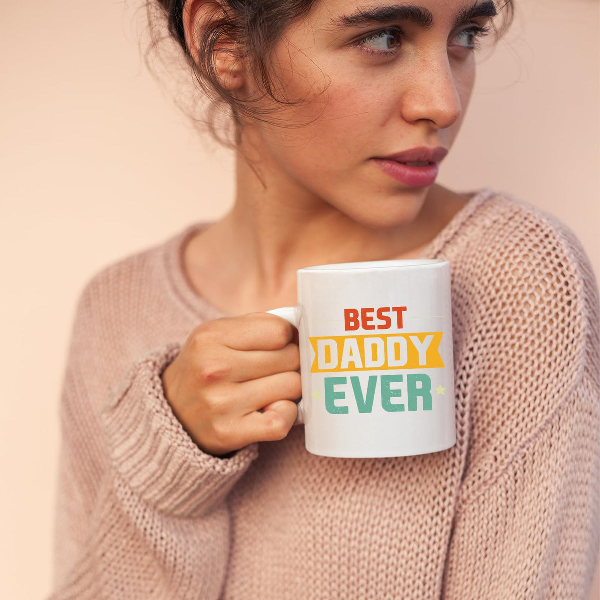 Woman in a pink jumper holding the Best Daddy Ever retro mug