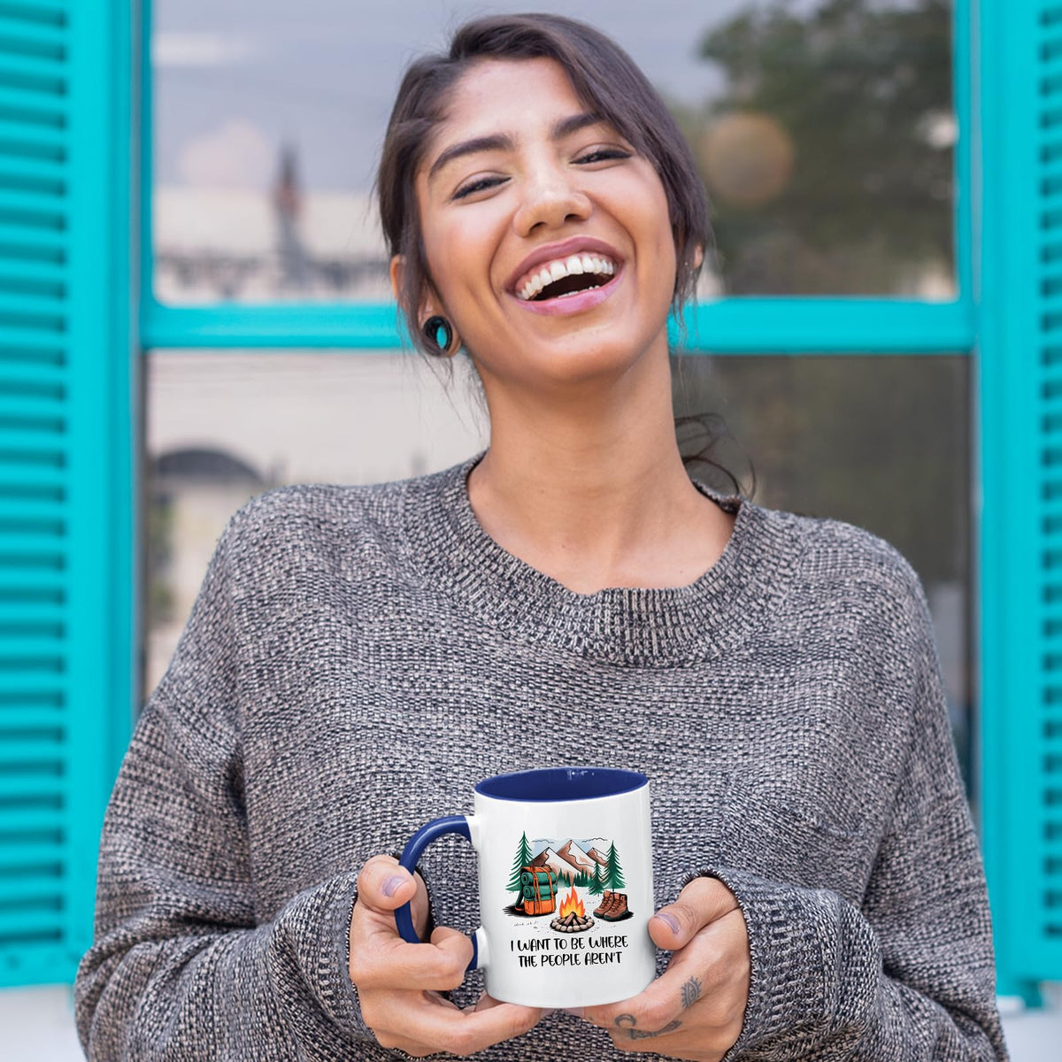 Laughing woman holding the camping escape mug with a dark blue handle