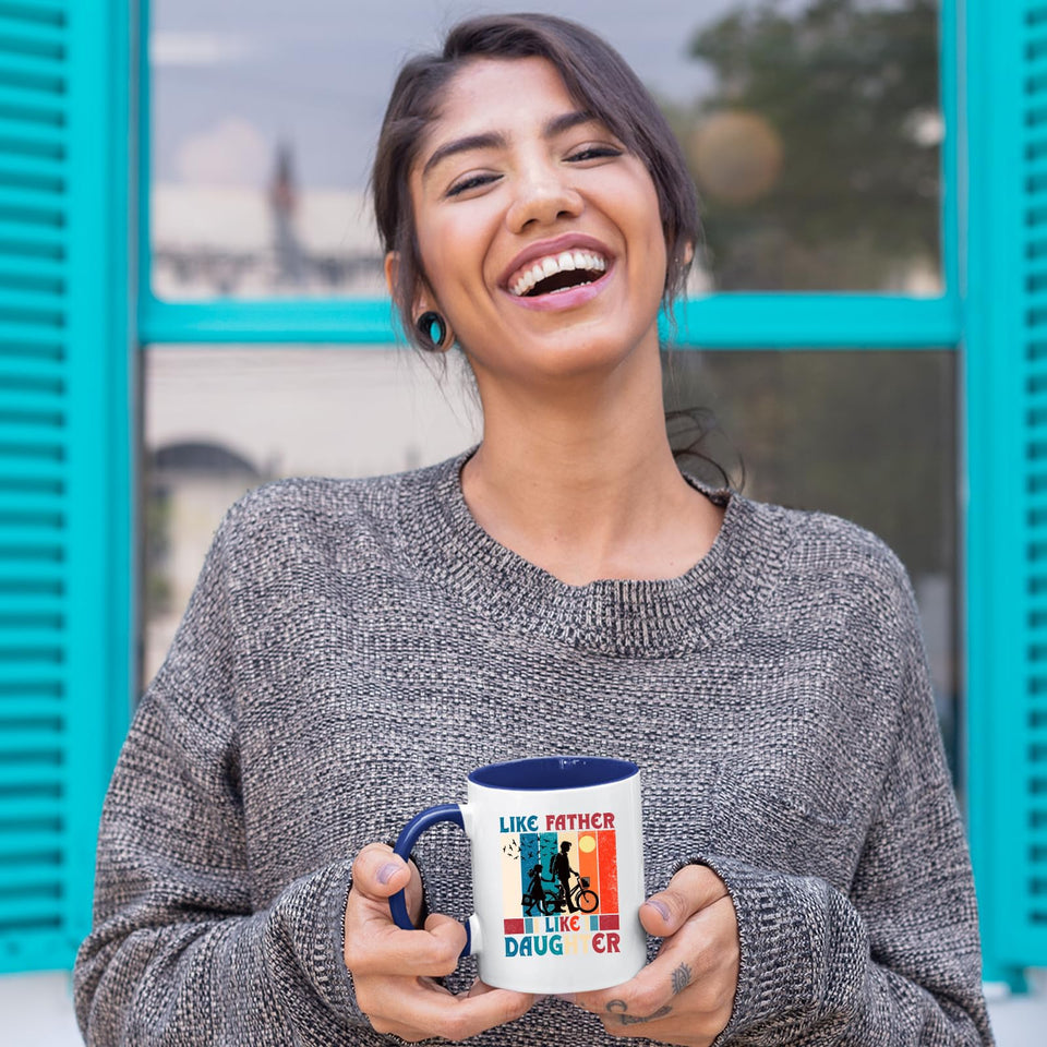 Laughing woman holding the Like Father Like Daughter mug with a dark blue handle