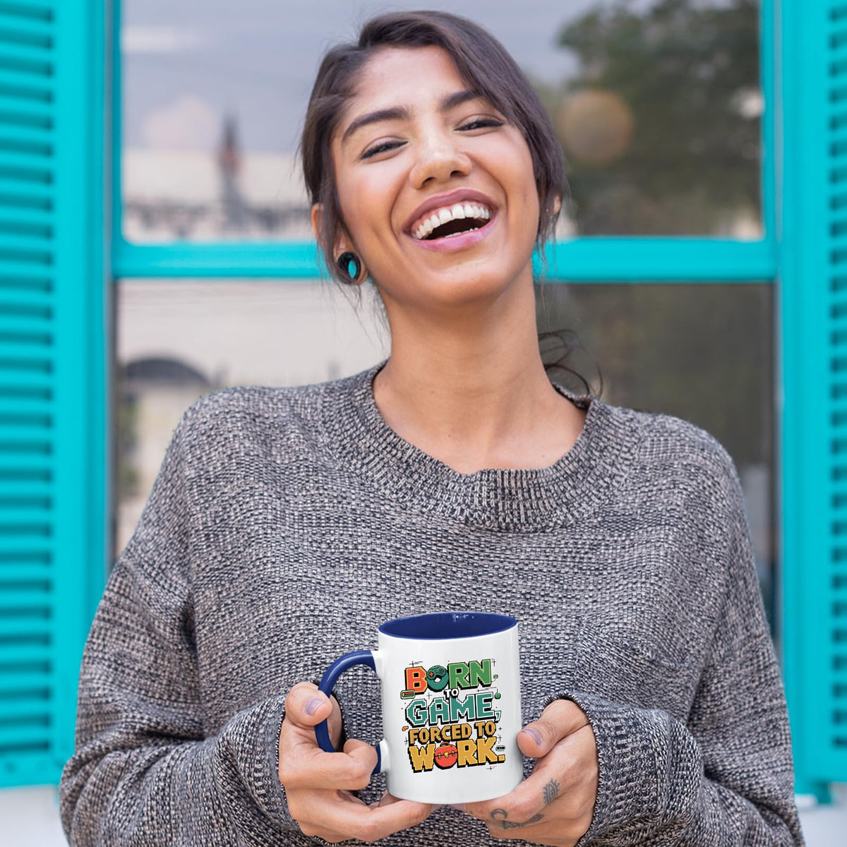 Laughing woman holding the Born to Game mug with a dark blue handle