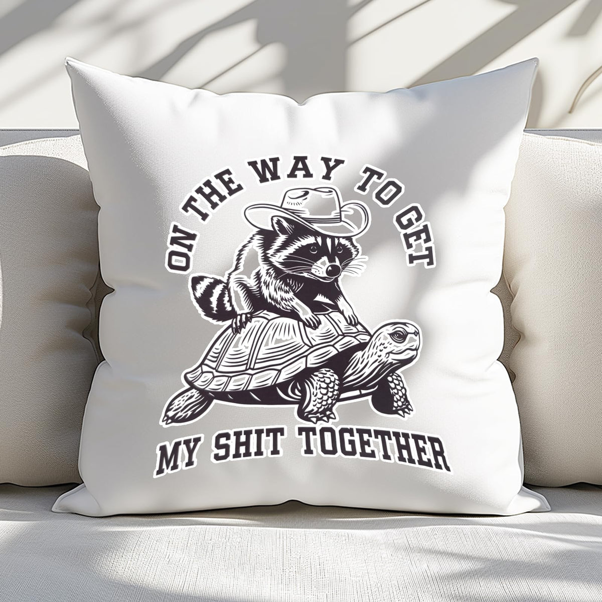 raccoon and tortoise cushion on a white sofa