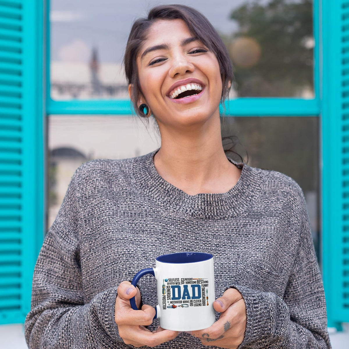 Laughing woman holding the DAD word cloud mug with a dark blue handle