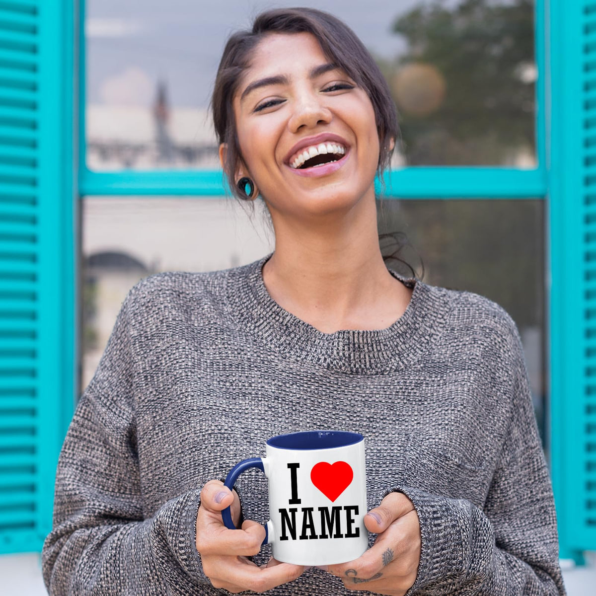 Smiling woman holding a personalised I love name mug