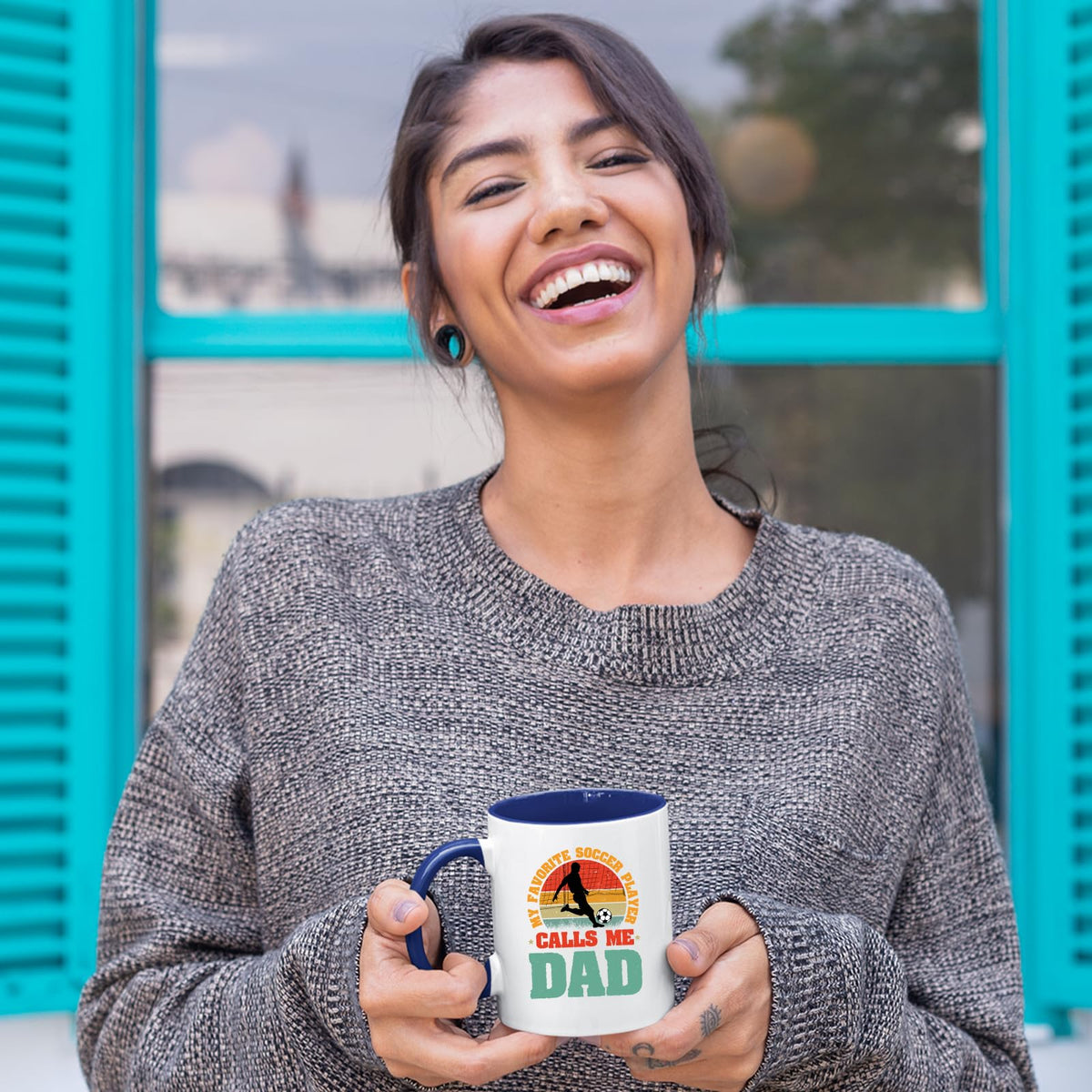 Laughing woman holding the Soccer Dad mug with a dark blue handle